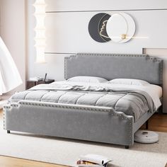 a bedroom with a bed, nightstand and rug