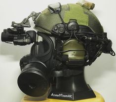 an army helmet and goggles on top of a mannequin's head