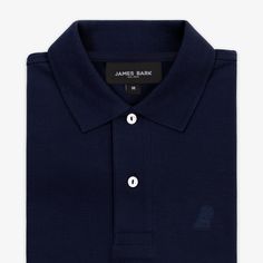 This men's classic piquŽ polo is a timeless must-have for any wardrobe. Crafted from the finest breathable Pima cotton, it features a sleek silhouette with an embroidered James Bark logo.Made in Peru100% Pima CottonEmbroidered James Bark LogoRibbed FinishesSide vents for added comfort Navy Fitted Cotton Polo Shirt, Classic Navy Polo Shirt With Johnny Collar, Navy Cotton Polo Shirt With Ribbed Collar, Classic Navy Fitted Polo Shirt, Classic Fitted Navy Polo Shirt, Classic Blue Polo Shirt With Embroidered Logo, Classic Blue Polo Shirt For Golf, Navy Collared Polo Shirt For Golf, Navy Fitted Polo Shirt