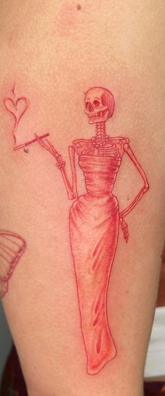 a woman with a skeleton tattoo on her thigh