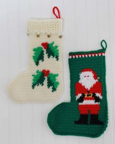 two christmas stocking ornaments are hanging on a white wall next to a green sock