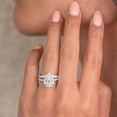 a woman's hand with a diamond ring on her finger and an engagement band