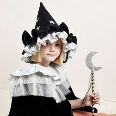 This witch's hat, with ruffle details, is very stylish indeed. It is crafted from black velvet, with silver lamé and silver glitter stars and moons. An essential accessory for Halloween, or to add to a dressing up box for imaginative play any time of the year. The hat is made from soft black velvet It has ruffle details on the brim made from black velvet and shiny silver lamé Silver glitter stars and moons add a delightful embellishment It has a fabric lining to give shape and support The black Childrens Halloween Costumes, Pierrot Clown, Creepy Costumes, Stars And Moons, Authentic Models, Meri Meri, Witch Costume, Glitter Stars, Turbans