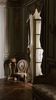 an ornately decorated room with a chair and table in front of a large window