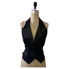 Moschnio black tuxedo jalter style top vest Be retro glam wearing this vintage tuxedo style vest / halter neck by Moschino. Pair with a pencil skirt or pencil pants and heels for a sexy date night look. Size 8 Across chest - 17 1/2 in. Across waist -14 1/2 in. Shoulder to hem - 24 in. front, 23 1/2 in. back Material: Feels like acetate/rayon blend. Made in Italy Halter Waistcoat, Nonbinary Prom Outfit, Black Vest Dress, Waistcoat Outfit Women, Waistcoat Women, Waistcoat Outfit, Color Block Coats, Polka Dot Blazer, Vintage Tuxedo