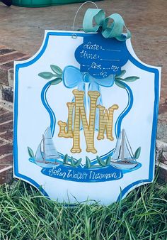 a blue and white sign sitting in the grass