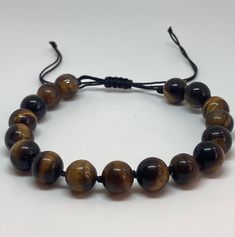 Tiger’s eye bracelet, tiger’s eye beads, root chakra bracelet, healing stone bracelet, chakra bracelet, handmade jewelry Adjustable Hand Wrapped Crystal Bracelet, Adjustable Casual Rosary Bracelet, Casual Adjustable Rosary Bracelet With Round Beads, Adjustable Braided Bracelets With 8mm Beads For Healing, Casual Adjustable Rosary Bracelet With 8mm Beads, Spiritual Adjustable Beaded Bracelets With Sliding Knot, Adjustable Brown Braided Bracelets For Healing, Adjustable Spiritual Stretch Bracelet Hand Wrapped, Casual Adjustable Crystal Bracelet For Meditation