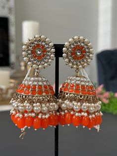 Lightweight jhumka earrings.  available in 2 colors- pearl, blue Earrings length- 4 inches Bollywood Beaded Earrings With Latkans For Celebration, Bollywood Style Beaded Earrings With Latkans For Celebration, Bollywood Chandbali Beaded Earrings For Celebrations, Orange Drop Earrings For Festive Occasion, Festive Orange Drop Earrings, Anarkali Style Chandbalis For Festivals And Parties, Traditional Orange Earrings For Party, Bollywood Chandbali Earrings With Latkans, Festive Bollywood Chandbali Beaded Earrings