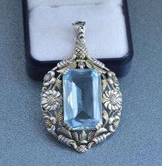 "Large highly detailed blue paste (glass) lightly gold washed 935 silver floral pendant. Stunning Art Nouveau jewelry piece! Height incl. loop 5.2 cm (2\"), width 3.2 cm (1.3\") Weight: 12.9 grams Hallmarked: 935 for high grade European silver Nice vintage condition, signs of wear to the paste The box on the photos for display only! Will be delivered by tracked and signed mail. Thank you for looking. Please see my other items." Antique Blue Jewelry With Large Pendant, Ornate Blue Engraved Jewelry, Antique Engraved Blue Jewelry, Antique Blue Engraved Jewelry, Vintage Blue Flower Pendant Jewelry, Floral Art Nouveau, Bijoux Art Nouveau, Nouveau Jewelry, Art Nouveau Jewelry