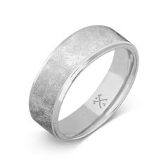 a white gold wedding ring with a textured finish and an engraved cross on the side