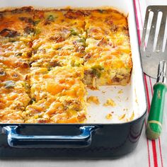 a casserole with meat and cheese in a blue dish next to a fork