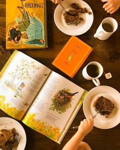 two children are eating cake and coffee at the table with an old - fashioned book