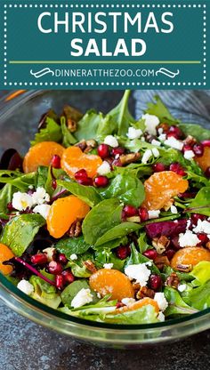 a salad with oranges, spinach and feta cheese in a glass bowl