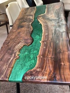 the table is made out of wood and has green, brown and blue paint on it