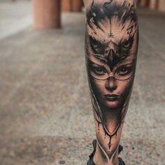 a woman's leg with an artistic tattoo on it