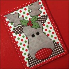 a christmas card holder with a reindeer on it's face and polka dots around the edges