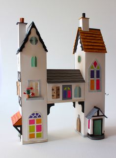 a doll house made out of paper with windows and doors