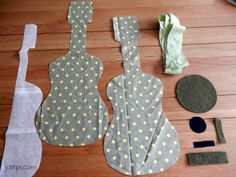 the sewing supplies are laid out on the wooden floor to be used for making guitars