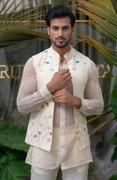 THE JACKET IS HAND EMBROIDERED WITH COLORFUL BEADS IN MOTIFS OF FLOWER AND CLOUDS FOR A CONTEMPORARY VIBE, DETAILED WITH RESHAM STEMS. THE JACKET IS OPEN FRON FRONT. Runit Gupta, India Fashion Men, Latest Kurta Designs, Mom And Son Outfits, Blazer Outfits Men