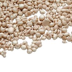 a pile of white beans sitting next to each other on top of a white surface