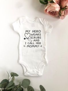 ---------- About the Product ---------- This personalized baby bodysuit is the perfect gift for a Nurse mommy-to-be!  Baby Bodysuit - Machine wash gentle cycle - Short Sleeve - Available in 5 sizes: Newborn, 3 Month, 6 Month, 9 Month, 12 Month (sizing chart in slides) - Design is applied in vinyl If you would like any changes to the design, send us a message! We would love to work with you to create a custom design. ---------- Ordering Instructions ---------- Please select bodysuit size from the drop down menu. In case of any customization: please make sure spelling is correct, as words will be copy-pasted. If the above information is not provided, we will message you once to request the missing information. If still not provided, we will have to cancel the order as this is a custom order. Customizable Cotton Onesie For First Birthday, White Short Sleeve Bodysuit As A Gift, White Short Sleeve Bodysuit As Gift, White Onesie With Custom Print For Parenting, White Personalized Short Sleeve Onesie, White Onesie With Custom Print, Mother's Day White Letter Print Bodysuit, White Short Sleeve Onesie For Mother's Day, Mother's Day White Onesie With Letter Print