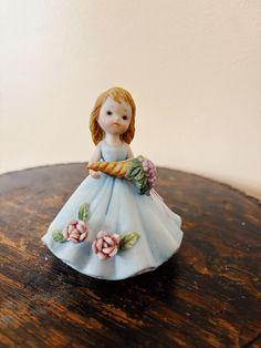 a small figurine sitting on top of a wooden table