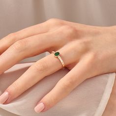 The Bezel Set Vintage Emerald Ring is a timeless expression of elegance and classic beauty. Crafted in 14k Solid Gold, this small oval engagement ring showcases a deep green emerald gemstone in a bezel setting. This ring embodies understated charm, making it an ideal choice for women who appreciate the simplicity and allure of emerald gemstones. The ring can be made with yellow, rose, or white gold, please choose your size from the dropdown menu options above. 𝐑𝐢𝐧𝐠 𝐃𝐞𝐭𝐚𝐢𝐥𝐬: ❥ Solid go Fine Jewelry Stackable Oval Solitaire Rings, Oval Solitaire Stackable Rings In Fine Jewelry Style, Elegant Gold Emerald Ring Oval Cabochon, Elegant Gold Emerald Oval Cabochon Ring, Minimalist Oval Solitaire Birthstone Ring, Elegant Oval Emerald Ring With Bezel Setting, Dainty Oval Solitaire Emerald Ring, Oval Dainty Rings With Simple Design, Dainty Oval Rings With Simple Design