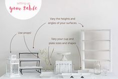 a white table topped with vases and other items next to a wall that says, setting up your table