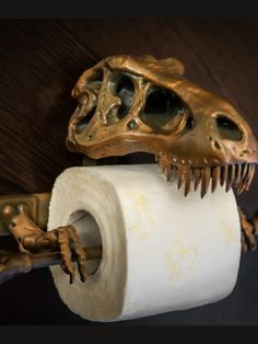 a close up of a toilet paper holder with a t - rexe on it