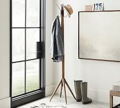 a coat rack in front of a large window