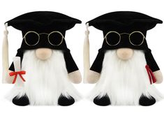 two black and white stuffed animals wearing graduation caps, gowns and tassels