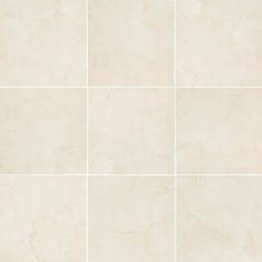 a white tile wall with four squares in it