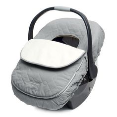 an infant car seat with a pillow on it