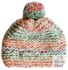 a multicolored knitted hat with a pom - pom on top