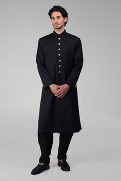 Black sherwani with gold plated button placket and side slits. Paired with kurta and pathani.
Components: 3
Neckline: Band collar
Sleeve Type: Full
Fabric: Silk
Color: Black
Other Details: 
Buttons
Attached lining
Length:
Sherwani: 42 inches
Sleeve: 26 inches
Pant: 42
Occasion: Mehendi and Puja - Aza Fashions Black Sherwani, Band Collar, Fabric Silk, Black Silk, Aza Fashion, Button Placket, Sleeve Type, Types Of Sleeves, For Men