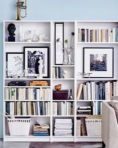 a white bookcase filled with lots of books