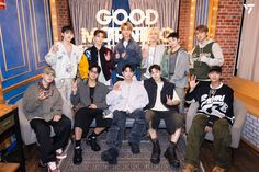 a group of young men posing for a photo in front of a sign that says good times