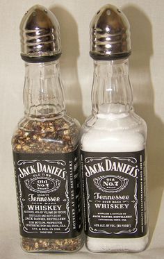 two bottles of jack daniels whiskey sitting next to each other