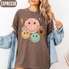 Sunflowers, Smiley Faces & Lightning Bolt Tee - Cozy Comfort Colors Shirt Brighten up your wardrobe with this adorable comfort colors shirt featuring smiley faces, a lighting bolt, and sunflowers! With a cheerful and colorful design, this shirt is perfect for adding a pop of fun to your everyday look. Made from soft and cozy fabric, it's both comfortable and stylish. Whether you're lounging at home or out and about, this shirt is sure to bring a smile to your face. Add this unique piece to your Cute Spring Tops With Smiley Face, Cute Smiley Face Tops For Spring, Cute Smiley Face Top For Spring, Spring Crew Neck Top With Smiley Face, Spring Smiley Face Crew Neck Top, Cute Smiley Face Tops For Summer, Cute Smiley Face Summer Tops, Short Sleeve Tops With Smiley Face For Spring, Spring Tops With Smiley Face, Short Sleeve