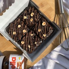 a box filled with chocolate covered pretzels on top of a wooden table