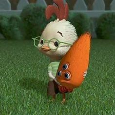 a chicken and a carrot are standing in the grass, one is wearing glasses while the other has an orange tail