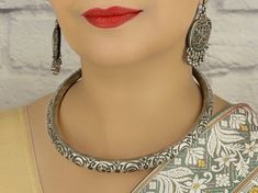 Beautifully handcrafted in Jaipur, this traditional tribal 925 sterling silver Hasli choker has an excellent finish which gives out an exquisite sense of style. What's Included: 1 925 Silver Hasli Choker Material: 92.5 Hallmarked Sterling Silver  Lock System: Twist/ Latch Finish: Oxidized Silver  Nickel Free/Lead free This is handcrafted item: Our 92.5 hallmarked sterling silver jewelry is handmade by skilled artisans in Rajasthan, India using traditional,  centuries old jewelry making techniques.  Packaging: * All jewelry pieces are sanitized and cleaned with jewelry cleaner before  packing. * All our jewelry pieces are delivered ready as gifts, packaged in a cotton filled paper box and a bow tie ribbon. Silver Care:  * Keep in cool dry place in plastic bag provided to avoid tarnishing. D