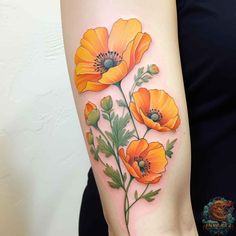 an orange flower tattoo on the arm