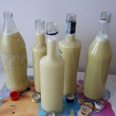 there are several bottles that have been placed on the table with their lids down and one is empty