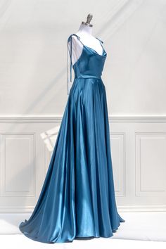 Channel Old-Hollywood glamour at your next event in the stunning Aphrodite Dress. Featuring a sweeping full, navy blue satin skirt, flattering cowl-neckline, and delicate tie shoulders, the Aphrodite will turn heads with its dramatic side slit. Paired with a clutch and heels, this dress will be the look of your dreams! Also Available in Emerald Green, Lavender, Blush Pink, Navy & Black. For Other Feminine, French-Inspired Formal Dresses See Our Event Dress Collection. . Details: XS: Bust 32", Wa Navy Blue Satin Skirt, Blue Satin Skirt, Aphrodite Dress, Green Lavender, Lavender Blush, French Girl Style, Event Dress, Formal Gown, Cowl Neckline