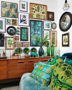 a living room filled with lots of pictures on the wall