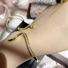 This snake bangle bracelet is perfect for the grunge girlies. The bangle itself is lined with a row of crystals, making it look luxurious and classy. Available in gold and silver. Grunge Jewelry Aesthetic, Bracelet Grunge, Grunge Jewelry, Yellow Gold Color, Snake Bracelet, Bangle Designs