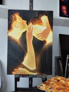 a painting of two people kissing in front of a pizza on an easel next to a table