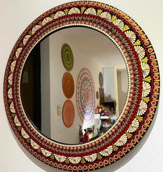 a round mirror hanging on the side of a wall