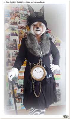 a person dressed as a fox holding a clock